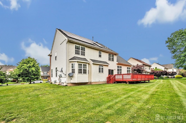 27 Rue Chagall, Franklin, NJ 08873 - rear view of property featuring a lawn, a deck, and roof mounted solar panels