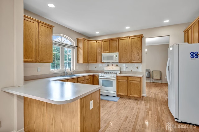 27 Rue Chagall, Franklin, NJ 08873 - kitchen featuring white appliances, a peninsula, light countertops, light wood-type flooring, and recessed lighting