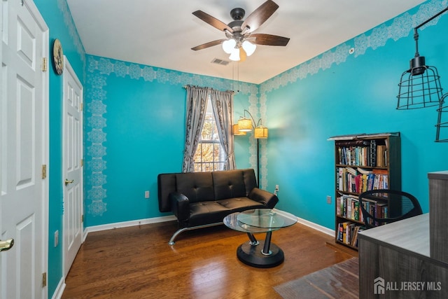 sitting room featuring ceiling fan and hardwood / wood-style floors