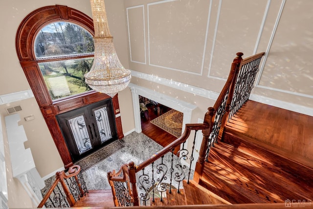 foyer with hardwood / wood-style flooring, a healthy amount of sunlight, and a chandelier