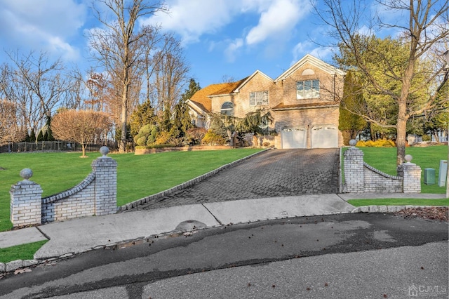 view of front of home with brick siding, a front yard, fence, a garage, and driveway