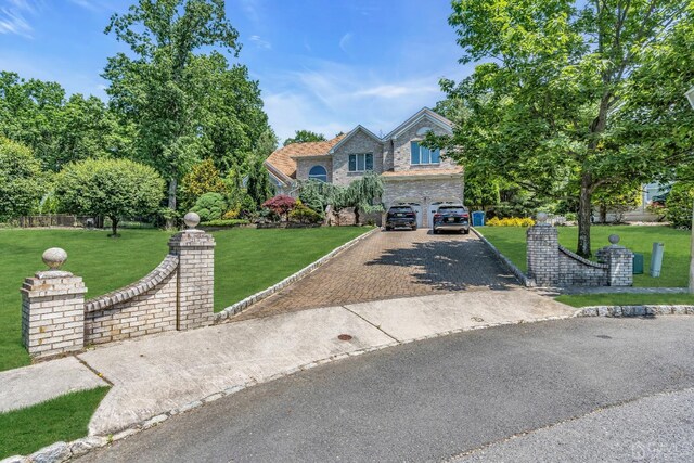 view of front facade featuring a front yard and a garage