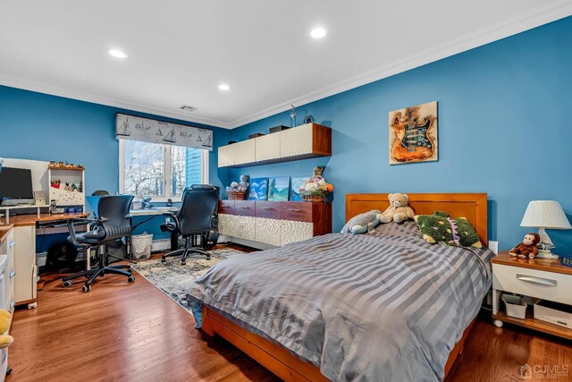 bedroom with crown molding and wood-type flooring