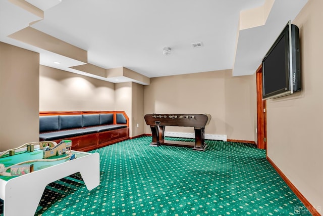 rec room with carpet floors, visible vents, and baseboards