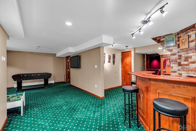 bar with rail lighting and dark colored carpet