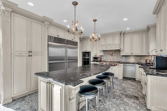 kitchen with tasteful backsplash, appliances with stainless steel finishes, a center island, granite finish floor, and recessed lighting