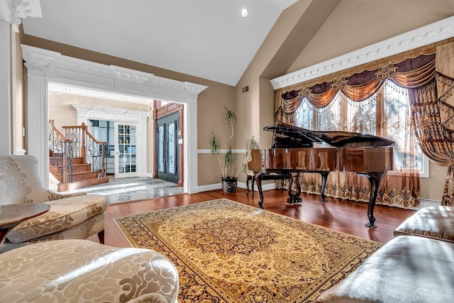 sitting room with lofted ceiling, visible vents, stairway, wood finished floors, and baseboards