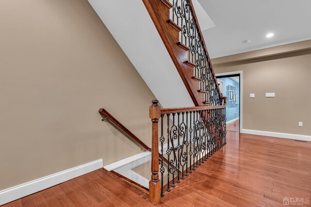 stairs featuring wood-type flooring