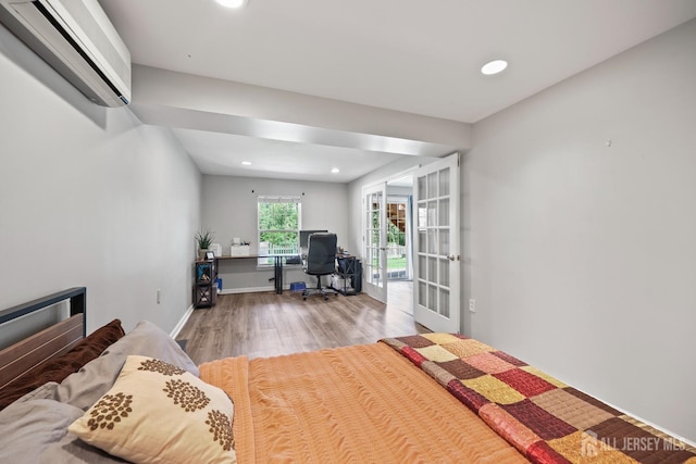 7 Cornell Dr, East Brunswick, NJ 08816 - bedroom with an AC wall unit, french doors, wood finished floors, an office area, and recessed lighting