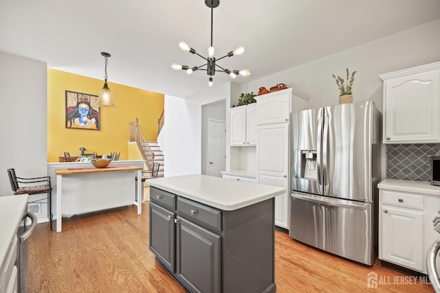 7 Cornell Dr, East Brunswick, NJ 08816 - kitchen with stainless steel appliances, white cabinets, light wood-style flooring, and gray cabinetry