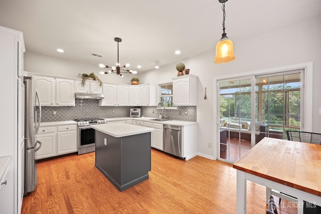 7 Cornell Dr, East Brunswick, NJ 08816 - kitchen featuring appliances with stainless steel finishes, light wood finished floors, white cabinetry, a chandelier, and recessed lighting