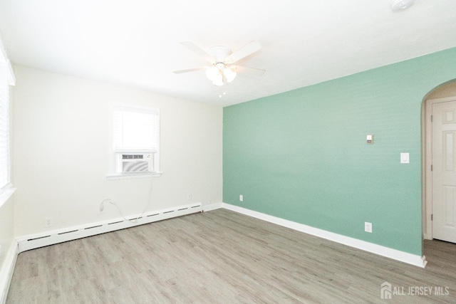 200 Plainfield Rd, Edison, NJ 08820 - empty room with a baseboard radiator, arched walkways, a ceiling fan, wood finished floors, and cooling unit