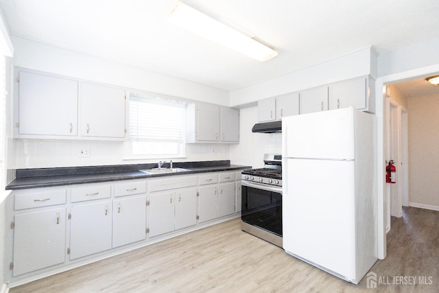 200 Plainfield Rd, Edison, NJ 08820 - kitchen featuring freestanding refrigerator, gas stove, under cabinet range hood, light wood-type flooring, and dark countertops