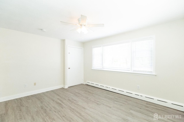 200 Plainfield Rd, Edison, NJ 08820 - spare room with a baseboard heating unit, wood finished floors, and ceiling fan