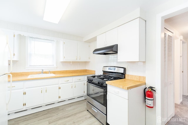 200 Plainfield Rd, Edison, NJ 08820 - kitchen with stainless steel range with gas stovetop, under cabinet range hood, light countertops, white cabinetry, and decorative backsplash