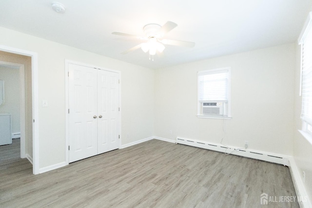 200 Plainfield Rd, Edison, NJ 08820 - unfurnished bedroom featuring a baseboard heating unit, wood finished floors, a closet, and ceiling fan
