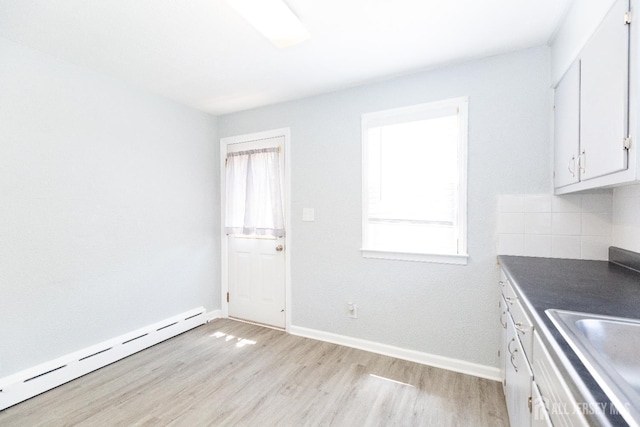 200 Plainfield Rd, Edison, NJ 08820 - kitchen with baseboard heating, light wood-style flooring, white cabinetry, dark countertops, and decorative backsplash