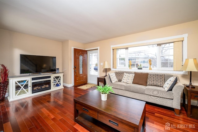 57 Athens Ave, Old Bridge, NJ 08879 - living area with wood finished floors, a glass covered fireplace, and baseboards