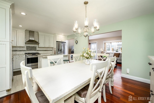 dining space with dark wood finished floors, a notable chandelier, recessed lighting, and baseboards