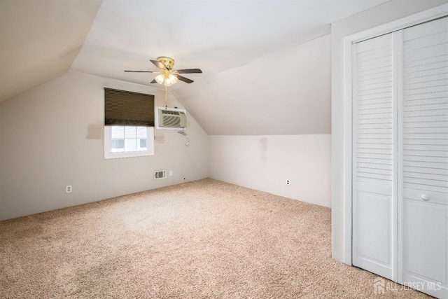 bonus room featuring a ceiling fan, carpet, visible vents, a wall mounted AC, and lofted ceiling