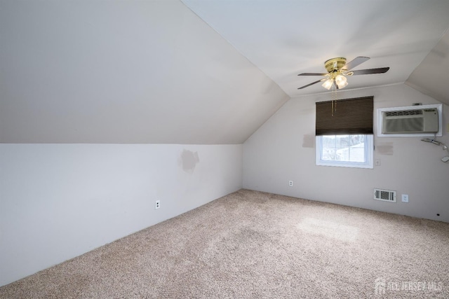 bonus room featuring a ceiling fan, visible vents, carpet floors, a wall mounted AC, and lofted ceiling