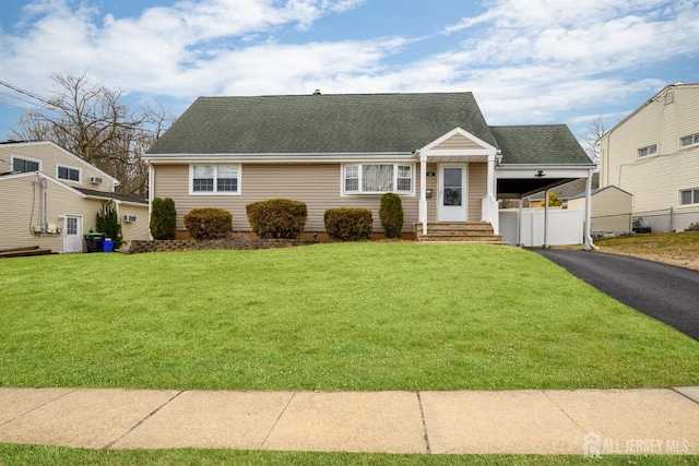 57 Athens Ave, Old Bridge, NJ 08879 - cape cod-style house featuring a shingled roof, asphalt driveway, a carport, and entry steps