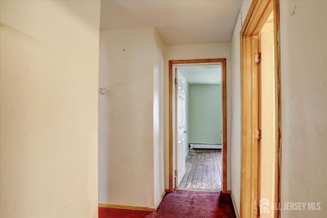 hall featuring carpet flooring and a baseboard heating unit