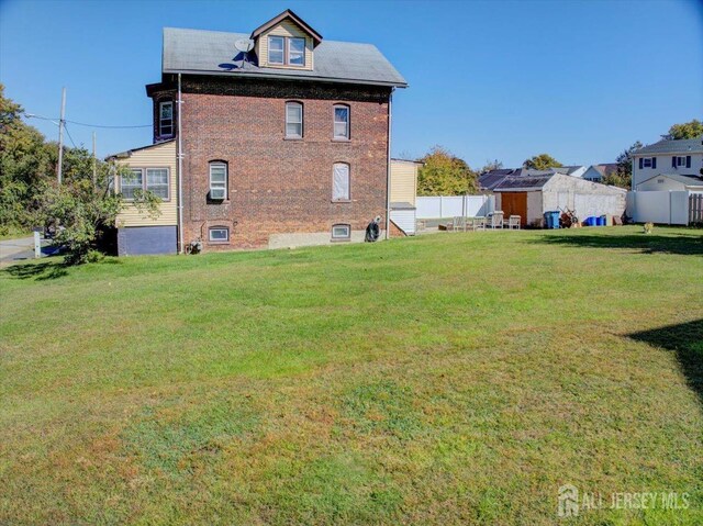 rear view of house featuring a lawn