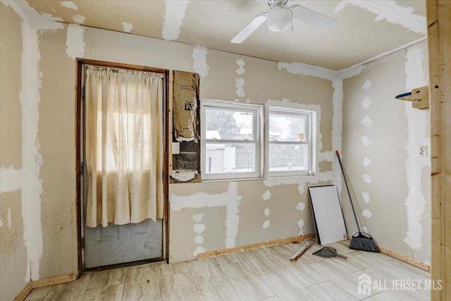 spare room with ceiling fan and light wood-type flooring