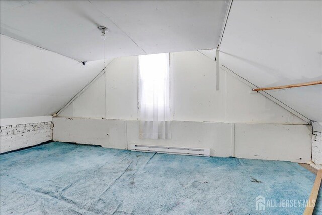 bonus room with lofted ceiling and a baseboard heating unit