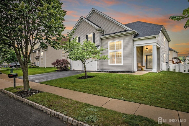 21 Dahlia Ct, Piscataway, NJ 08854 - view of front facade with driveway, an attached garage, and a shingled roof