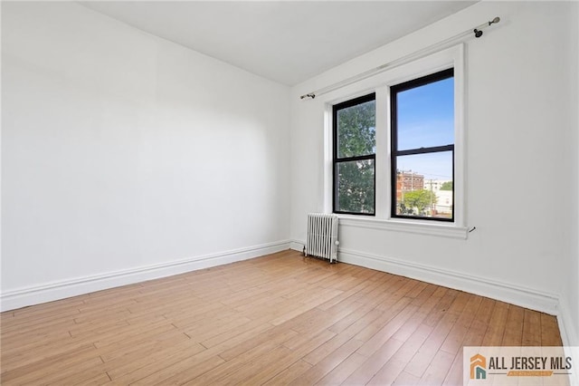 57 Corbin Ave Unit 24, Jersey City, NJ 07306 - spare room with radiator and wood finished floors