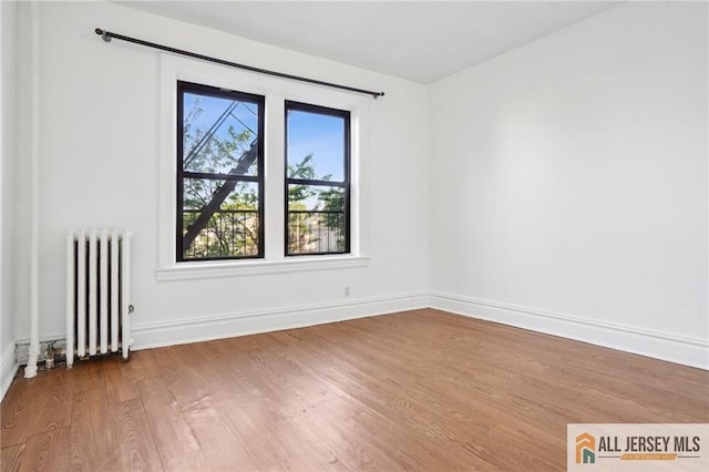 57 Corbin Ave Unit 24, Jersey City, NJ 07306 - empty room featuring radiator heating unit and wood finished floors