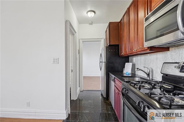 57 Corbin Ave Unit 24, Jersey City, NJ 07306 - kitchen featuring stainless steel appliances, granite tiled floors, dark countertops, and backsplash