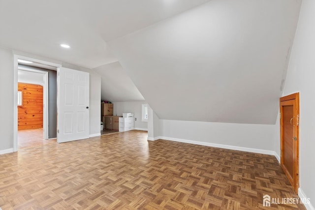 additional living space with lofted ceiling, baseboards, and recessed lighting