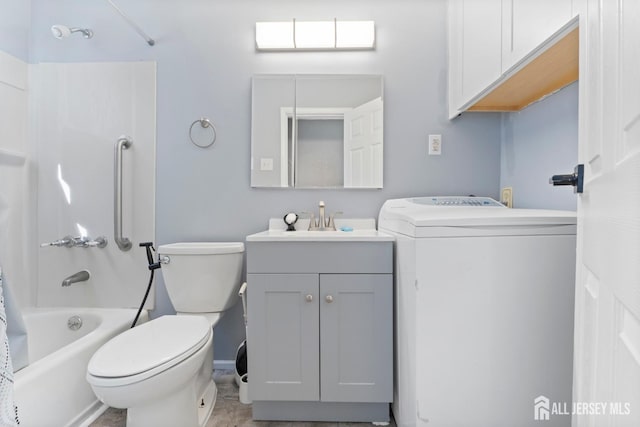 bathroom with toilet, washer / clothes dryer, shower / bath combo with shower curtain, and vanity