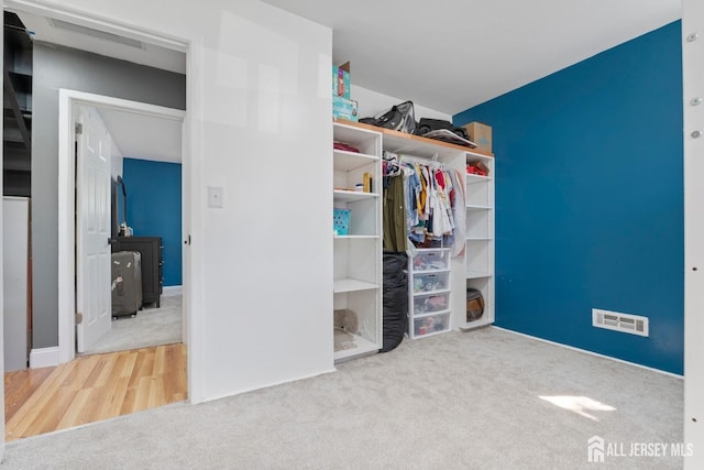 unfurnished bedroom with a closet, carpet flooring, and visible vents