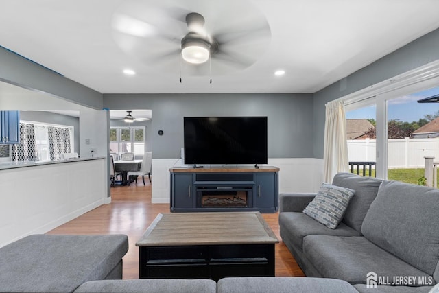 living room featuring recessed lighting, ceiling fan, wood finished floors, and wainscoting