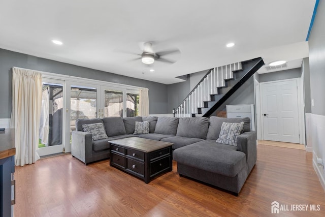 living room featuring recessed lighting, visible vents, ceiling fan, wood finished floors, and stairs