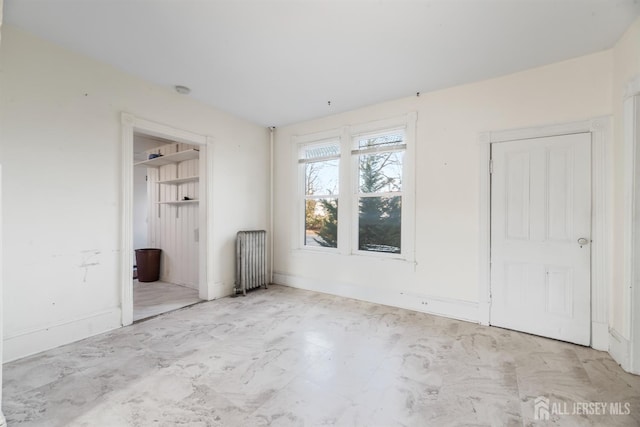 unfurnished bedroom featuring radiator heating unit