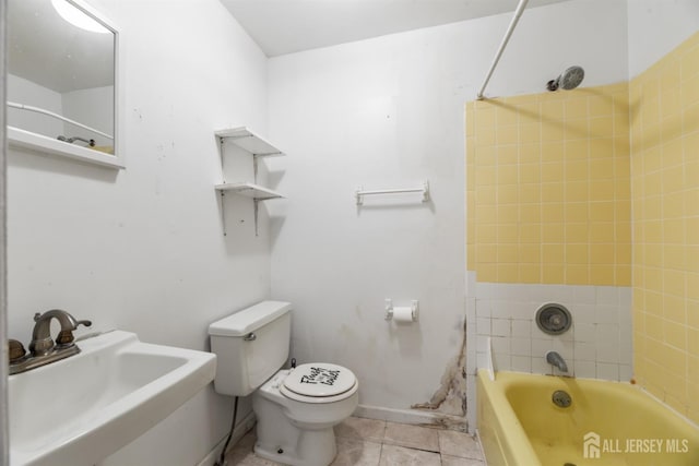 full bathroom featuring sink, toilet, tiled shower / bath combo, and tile patterned flooring