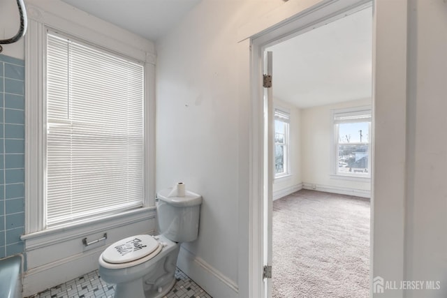 bathroom with baseboards and toilet