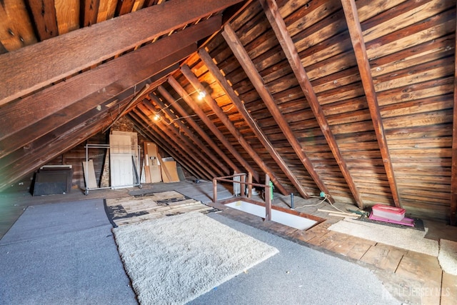 unfinished attic with an upstairs landing