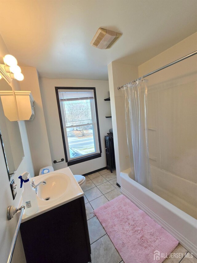 full bathroom featuring vanity, tile patterned floors, toilet, and shower / bath combo with shower curtain