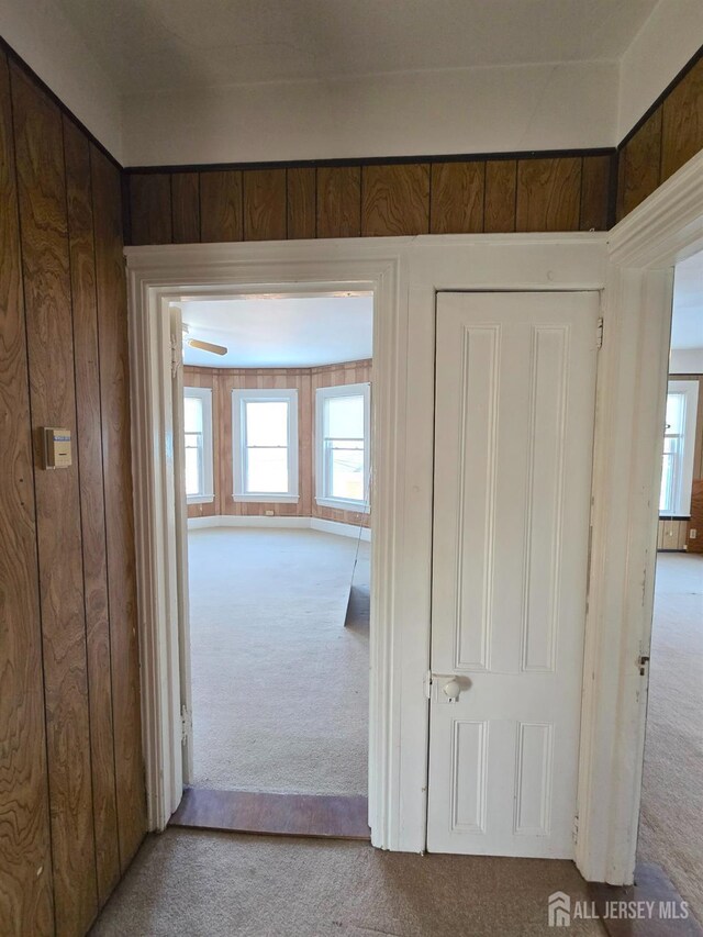 hall featuring light colored carpet