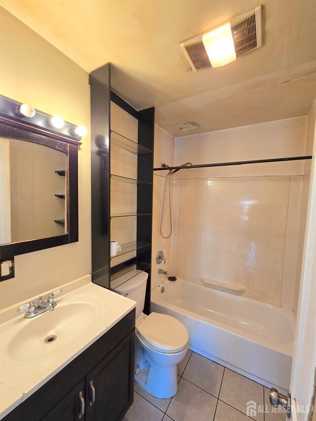 full bathroom featuring vanity, tile patterned floors, toilet, and bathtub / shower combination