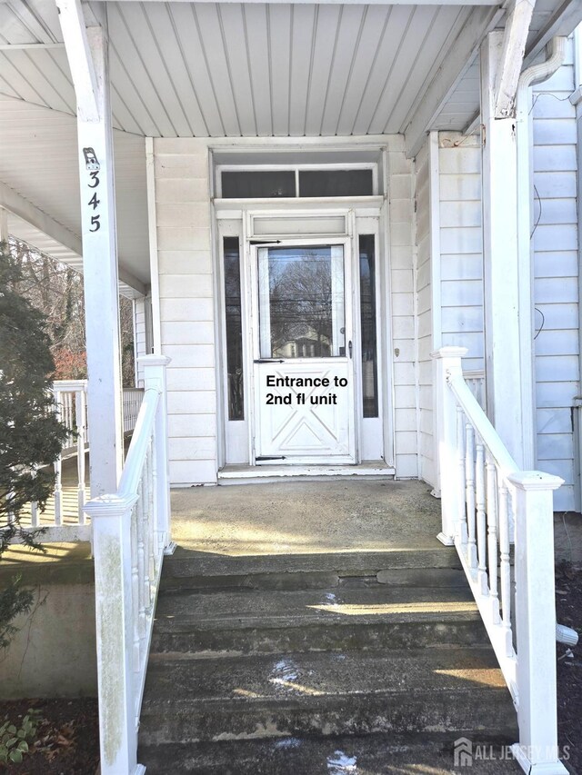 view of exterior entry featuring a porch