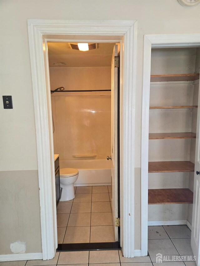 bathroom with vanity, tile patterned floors, and toilet