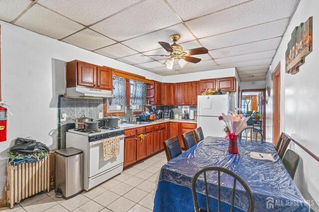 349 Livingston Ave, New Brunswick, NJ 08901 - kitchen featuring white appliances, under cabinet range hood, a drop ceiling, a ceiling fan, and a sink