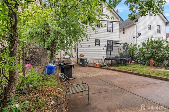 349 Livingston Ave, New Brunswick, NJ 08901 - back of house featuring a trampoline and a patio area